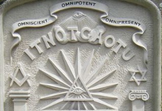 Various freemasonry symbols on a gravestone